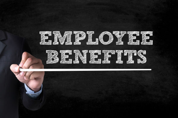 Businessman drawing 'Employee Benefits' on a blackboard